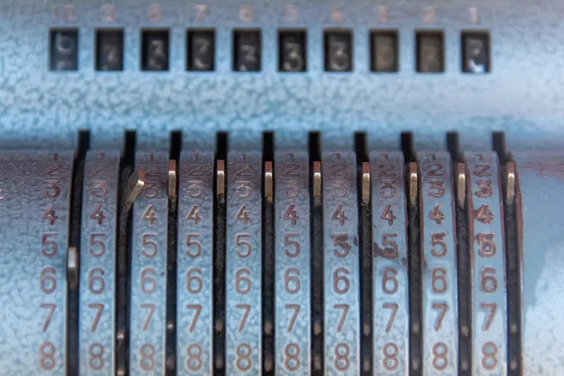 Numbered keys of an old mechanical calculator arranged in columns.